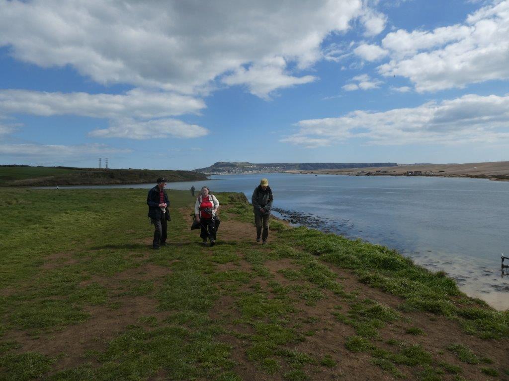 3 Walkers alongside the river